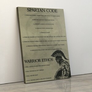 May include: A motivational poster with a Spartan warrior graphic and text that reads "Spartan Code" and "Warrior Ethos". The text outlines the code of conduct for a Spartan warrior, including phrases like "A Spartan pushes their mind and body to their limits" and "A Spartan lives every day as if it were their last". The text also includes the warrior ethos, which includes phrases like "I will always place the mission first" and "I will never leave a fallen comrade".