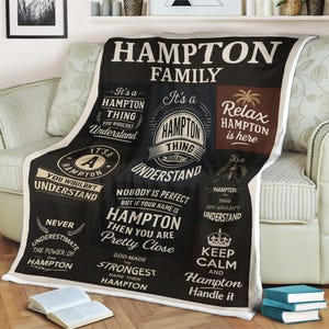 May include: Black Hampton family blanket with white text. The blanket features phrases like "Hampton Thing You Wouldn't Understand" and "Relax Hampton is here". The blanket is draped over a sofa.