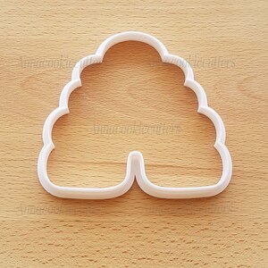 May include: White plastic cookie cutter shaped like a beehive.