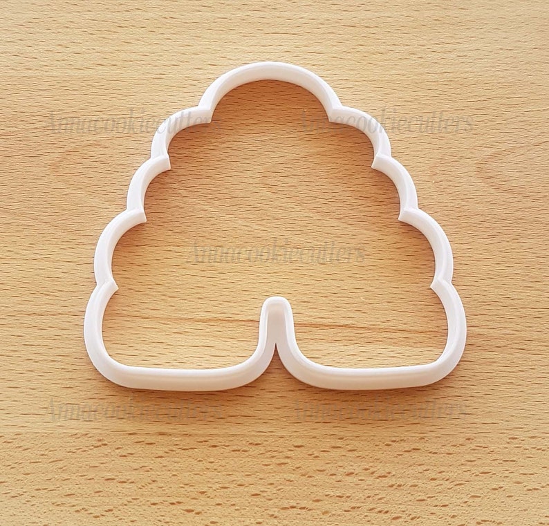May include: White plastic cookie cutter shaped like a beehive.