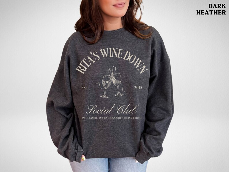 a woman wearing a sweatshirt with a wine glass on it