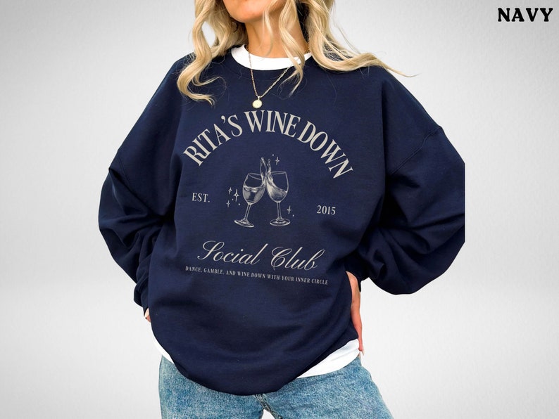 a woman wearing a sweatshirt with a wine glass on it