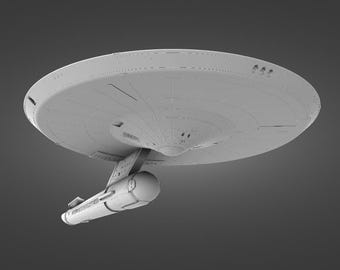 May include: A gray model of a starship with a saucer-shaped main body and a cylindrical nacelle attached to the bottom.