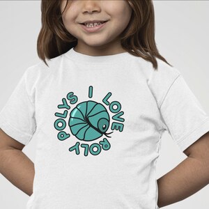May include: White t-shirt with a blue and black graphic of a roly poly with the text "I Love Roly Polys" around it.