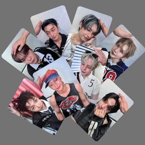 May include: A collection of seven rectangular photo cards featuring portraits of young individuals with diverse hairstyles and clothing, including a black and white jersey with the number 13, a white polo with the number 5, and a black graphic tank top.