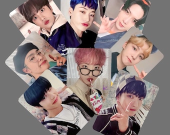 May include: A collection of seven photo cards featuring young men. Each card displays a different individual, with various hairstyles and expressions. The cards are arranged in a circular pattern against a gray background. The images are brightly lit and appear to be professionally taken.