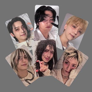 May include: A collection of six photo cards featuring portraits of young people with various hairstyles and expressions. The cards have a white grid pattern background and are arranged in a circular fashion against a gray backdrop.