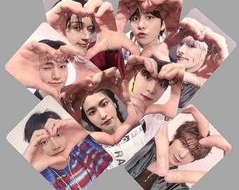 May include: A collage of nine photos featuring different people making heart shapes with their hands. Each photo has a different person with a unique hairstyle and clothing style.