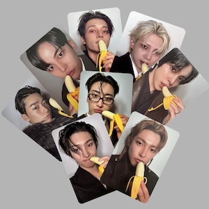 May include: A collection of rectangular photo cards featuring various individuals holding peeled bananas. The cards have a white border and a light gray background. The people in the photos have different hairstyles and are wearing various outfits.