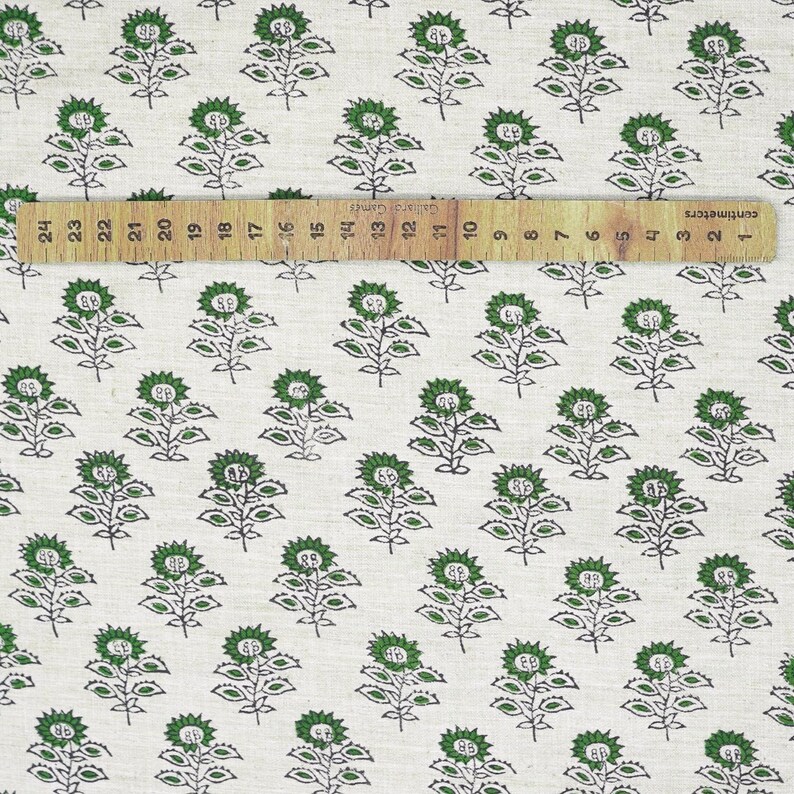 Hand block printed green foliage on beige linen blend, eco-friendly fabric crafted with Indian artisan skill for decorative home accents.