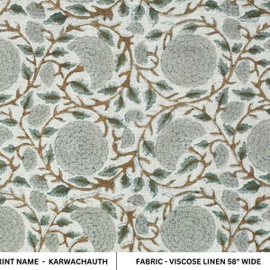 May include: A piece of viscose linen fabric featuring a repeating floral pattern with light gray circular flower heads and brown vine-like stems with green leaves on an off-white background. The text reads PRINT NAME - KARWACHAUTH FABRIC - VISCOSE LINEN 58" WIDE.