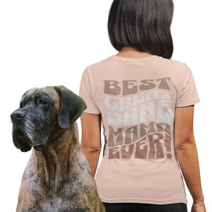 May include: A pink t-shirt with the text "BEST GREAT DANE MAMA EVER!" in a retro font. The text is in shades of brown, pink, and white.