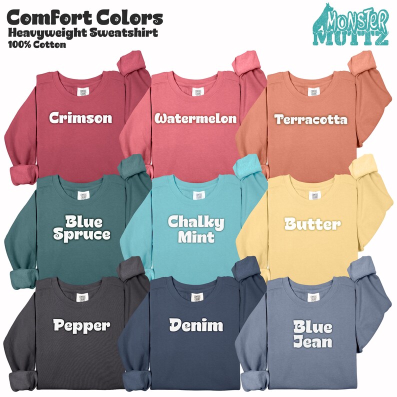 May include: A collection of Comfort Colors heavyweight sweatshirts in various colors, including crimson, watermelon, terracotta, blue spruce, chalky mint, butter, pepper, denim, and blue jean. Each sweatshirt is 100% cotton and features the brand name "Monster Muttz".