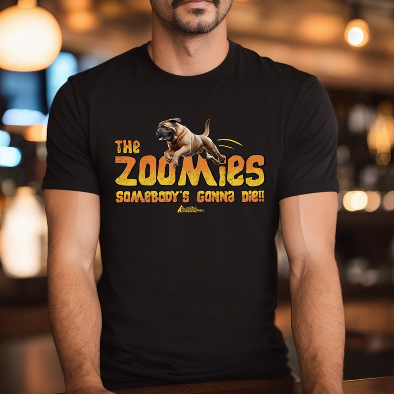 May include: Black t-shirt featuring a graphic of a brown dog jumping and the text "The Zoomies Somebody's Gonna Die!"