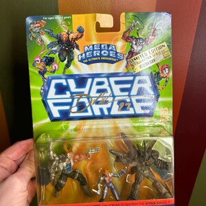 May include: Sealed Cyber Force action figure set. The packaging features the text "MEGA HEROES THE ULTIMATE ENCOUNTER" and "CYBER FORCE 97". The set includes Major Stryker, Ballistic, and Attack S.H.O.C. figures. The packaging is green and blue.