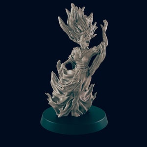 May include: A gray, ghostly figure with flowing hair and a long, flowing robe. The figure is holding its hands up in a gesture of anger or fear. The figure is standing on a black base.