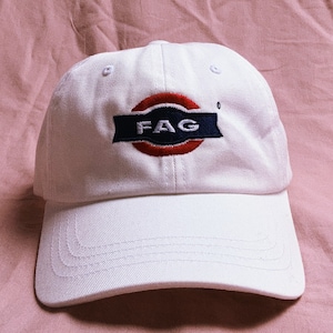 May include: White baseball cap with a red and blue embroidered patch that says "FAG" in a circle.