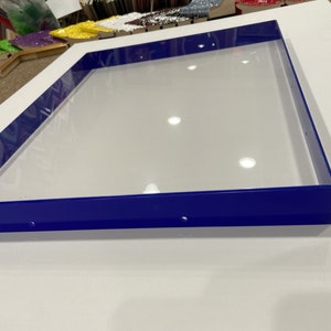 May include: A blue frame with a white background. The frame is made of metal and has a smooth finish.