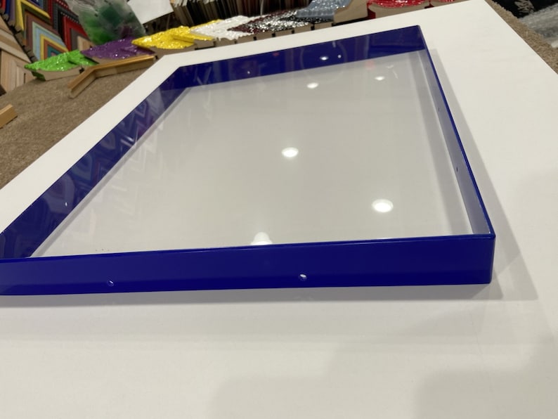 May include: A blue frame with a white background. The frame is made of metal and has a smooth finish.