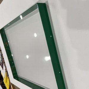 May include: A green metal frame with a square shape. The frame is made of metal and has a smooth, glossy finish.