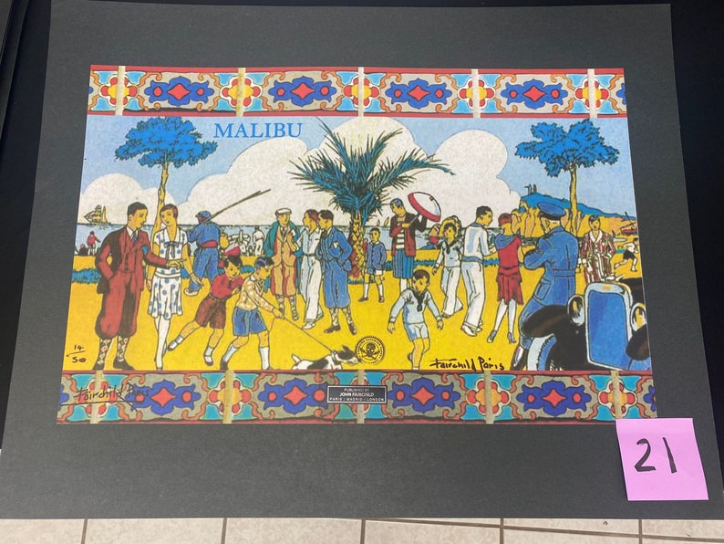 May include: A colorful vintage illustration of people on a beach in Malibu, California. The illustration features a palm tree, a car, and a dog. The text "MALIBU" is printed at the top of the illustration.