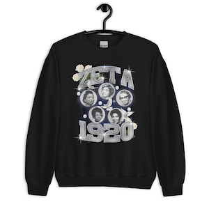 May include: Black sweatshirt with a silver graphic of five women's faces in circles with the text "ZETA 1920" in silver with white roses and sparkles.