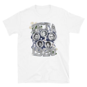 May include: White t-shirt with a silver graphic of the word "ZETA" and the year "1920" surrounded by images of four women and white flowers.