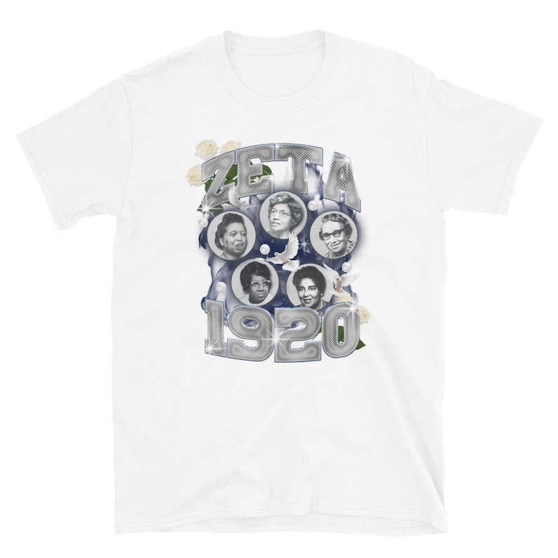 May include: White t-shirt with a silver graphic of the word "ZETA" and the year "1920" surrounded by images of four women and white flowers.