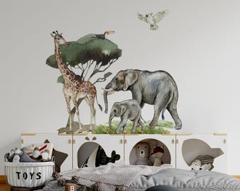 May include: A wall decal set featuring watercolor illustrations of a giraffe, an adult elephant, a baby elephant, a toucan, and a white bird. The animals are depicted in natural tones of brown, gray, and green, arranged as a cohesive jungle scene.