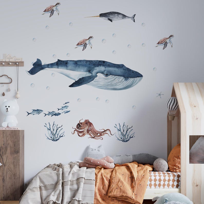 Under the sea octopus wall decal and whale stickers featuring watercolor sea life for a nursery.