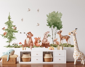 May include: A wall decal set featuring watercolor illustrations of a brown bear, a squirrel, a rabbit, a deer, and a fawn in a forest setting with green trees, mushrooms, and butterflies. The scene includes a tall pine tree and a deciduous tree.