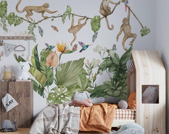 May include: A wall decal featuring watercolor illustrations of monkeys, a parrot, butterflies, and hummingbirds amidst lush green tropical foliage and flowers. The scene includes large monstera leaves, bird of paradise flowers, and hanging vines.