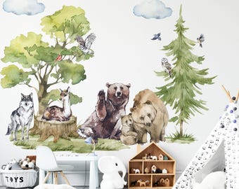 May include: A wall decal set featuring watercolor illustrations of a forest scene with a brown bear, a cub, a wolf, a deer, owls, birds, green trees, and blue clouds. The artwork displays various woodland animals in a natural habitat setting.