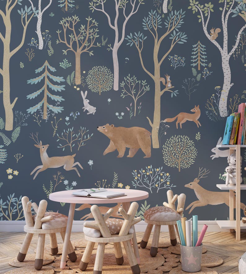May include: A children's playroom with a blue and green woodland mural featuring a bear, deer, fox, and rabbit. A pink table with three wooden deer-shaped chairs sits in front of the mural.