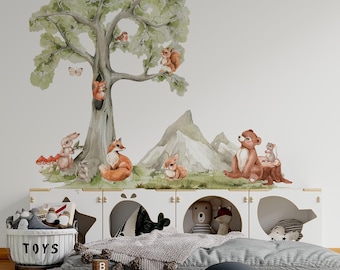 May include: A wall decal set featuring a large watercolor tree with a squirrel, bird, and butterfly, alongside a fox, rabbit, bear, and mouse in a mountain landscape. The scene includes red mushrooms and green grass, creating a forest theme.