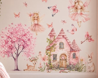 May include: A wall decal set featuring two blonde fairies in pink dresses, a pink cottage with a wooden door, a blooming cherry blossom tree, a fawn with a flower crown, a rabbit, several butterflies, dragonflies, and a decorative ornate key.
