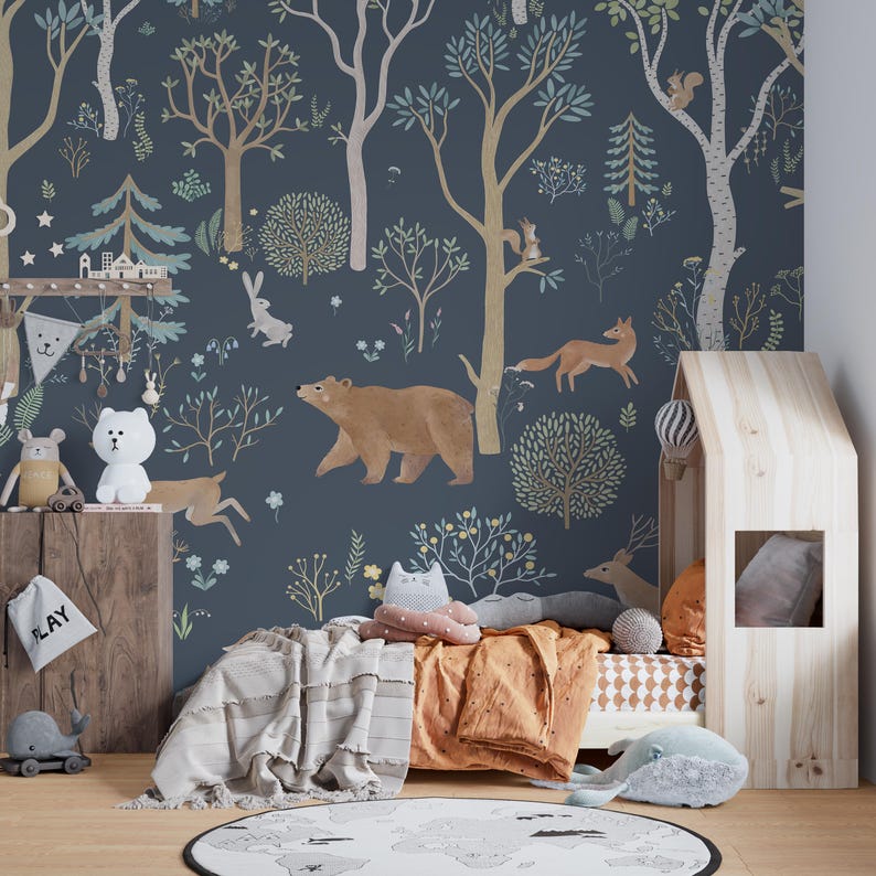 May include: A blue and brown illustrated wallpaper featuring a forest scene with animals such as a bear, fox, deer, and squirrel. The wallpaper is in a child's bedroom with a wooden bed and a stuffed animal.