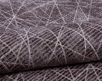May include: Close-up of a textured fabric with a geometric pattern in shades of brown and white.