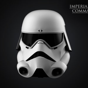 May include: A white Imperial Navy Commando helmet with a black visor and a black mouthpiece. The helmet has a black stripe on each side and the text "IMPERIAL NAVY COMMANDO" is printed in black at the top.