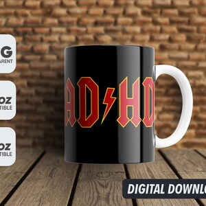 May include: A black and white mug with a red and yellow graphic that says "ADHD" on it. The mug has a white handle.
