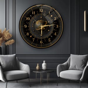 May include: A round wall clock featuring a black face with gold celestial motifs, including a central planet with rings, stars, and constellations. The clock has gold Arabic numerals from 1 to 12 and gold hands, all encased in a smooth glass cover.