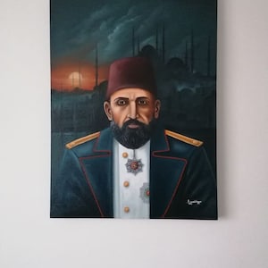May include: A painting of a man in a dark blue suit with a red fez. He has a beard and mustache and is wearing a military medal. The background is a dark blue with a cityscape and a sunset.