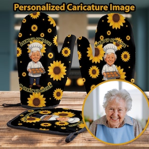 Puede incluir: Juego de manoplas y salvamanteles negros con diseño de girasoles y chef de dibujos animados. El texto dice "Baking Up Some Love In Grandma's Kitchen". El chef sostiene una bandeja de galletas. El juego está personalizado con una caricatura.