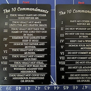 May include: Two rectangular black cards featuring white text listing The 10 Commandments. The left card displays the traditional King James version, while the right card presents a simplified modern version. Both cards are labeled Front and Back.