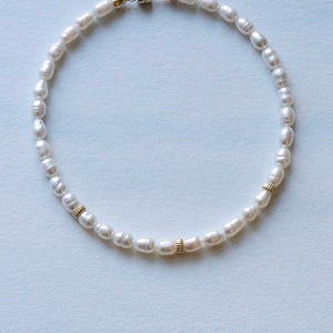 Bridal pearl anklet on blue background