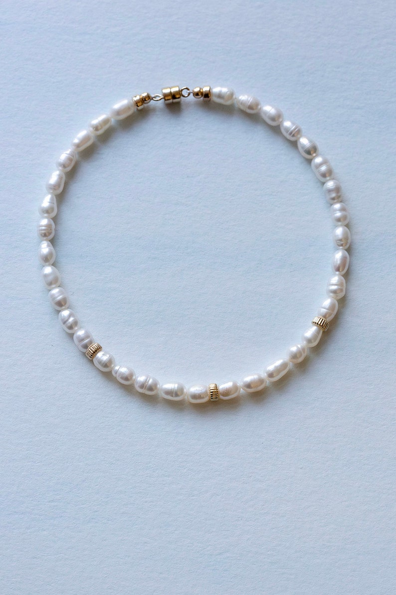 Bridal pearl anklet on blue background