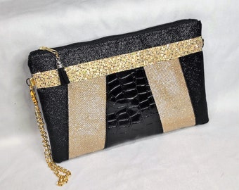 Clutch plano con cremallera y purpurina negra y dorada para cóctel de noche de bodas