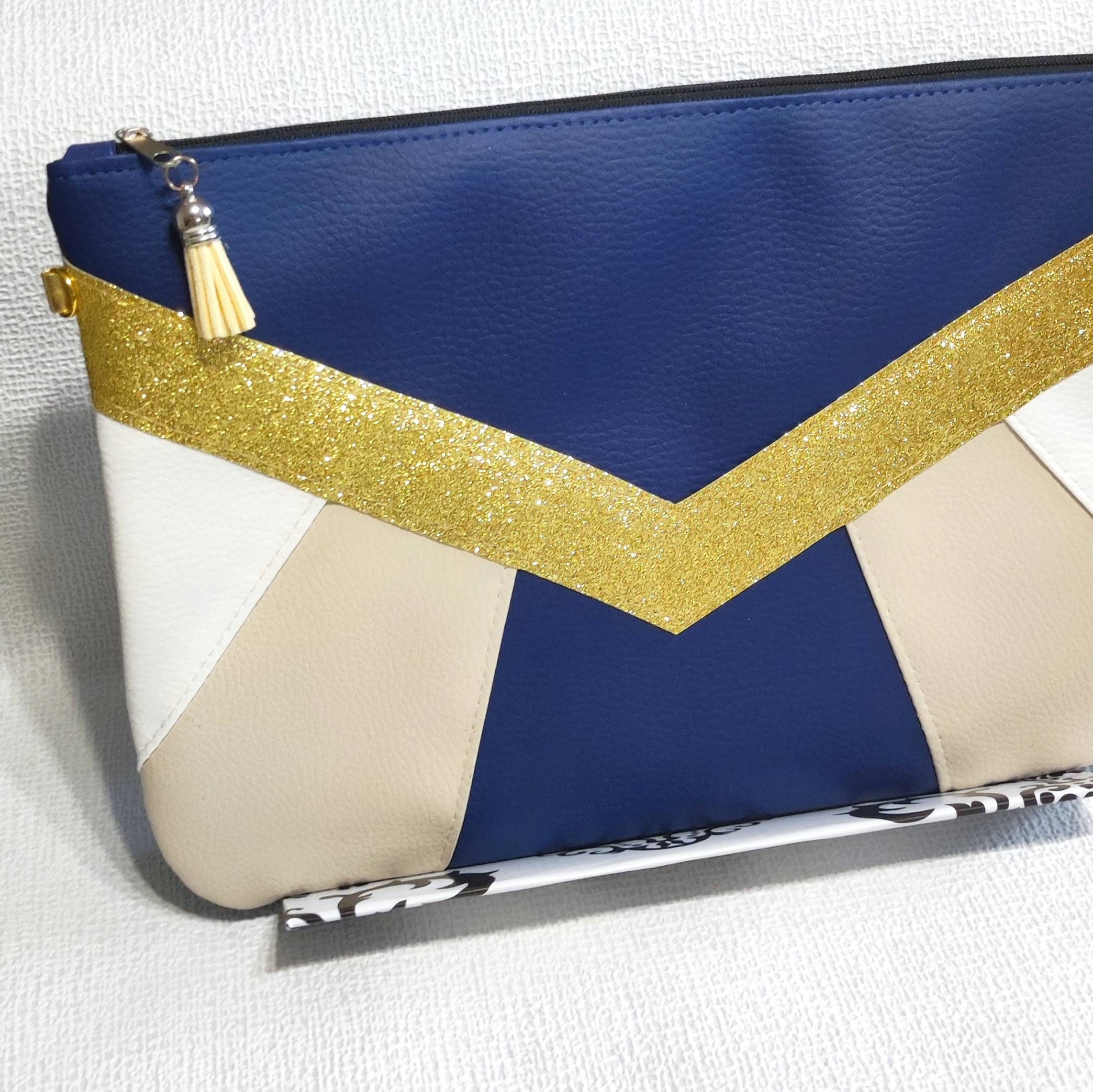 Navy and store white clutch bag