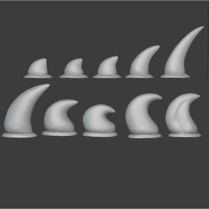 May include: Set of ten 3D printed plastic dinosaur claws in various sizes. The claws are gray and have a smooth, rounded finish.