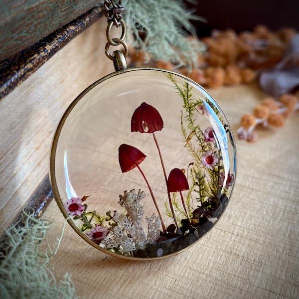 Real pink mushroom terrarium pendant. Botanical fairy forest necklace made from resin, moss, sand, leaves, flowers & fungi.